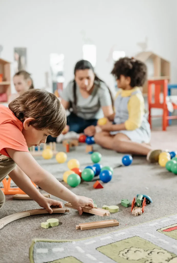 Children with ABA therapist learning social skills through interactive play activities at The Buddy Center Greenville SC